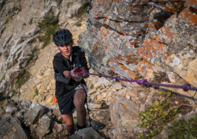 Racer climbing rope